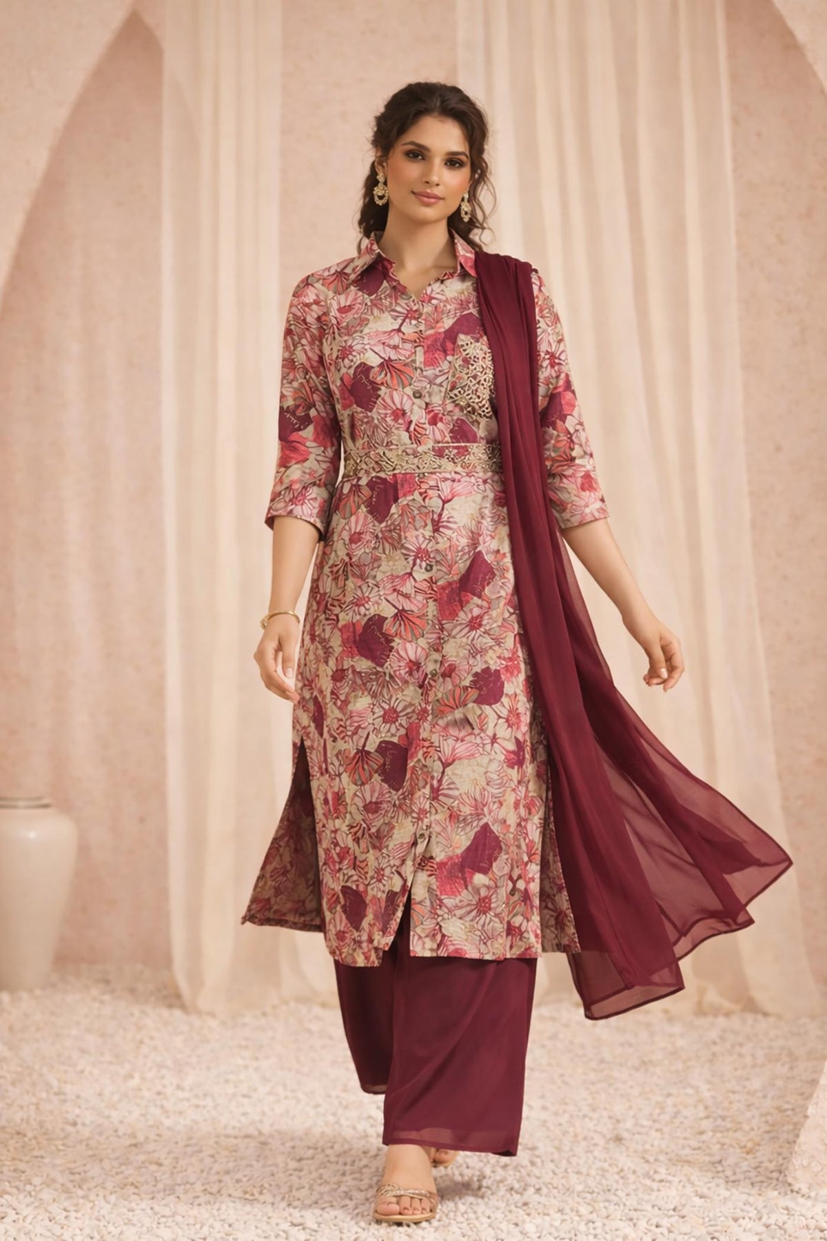 Maroon floral kurta set with palazzo and dupatta, front walking view with gold sandals.