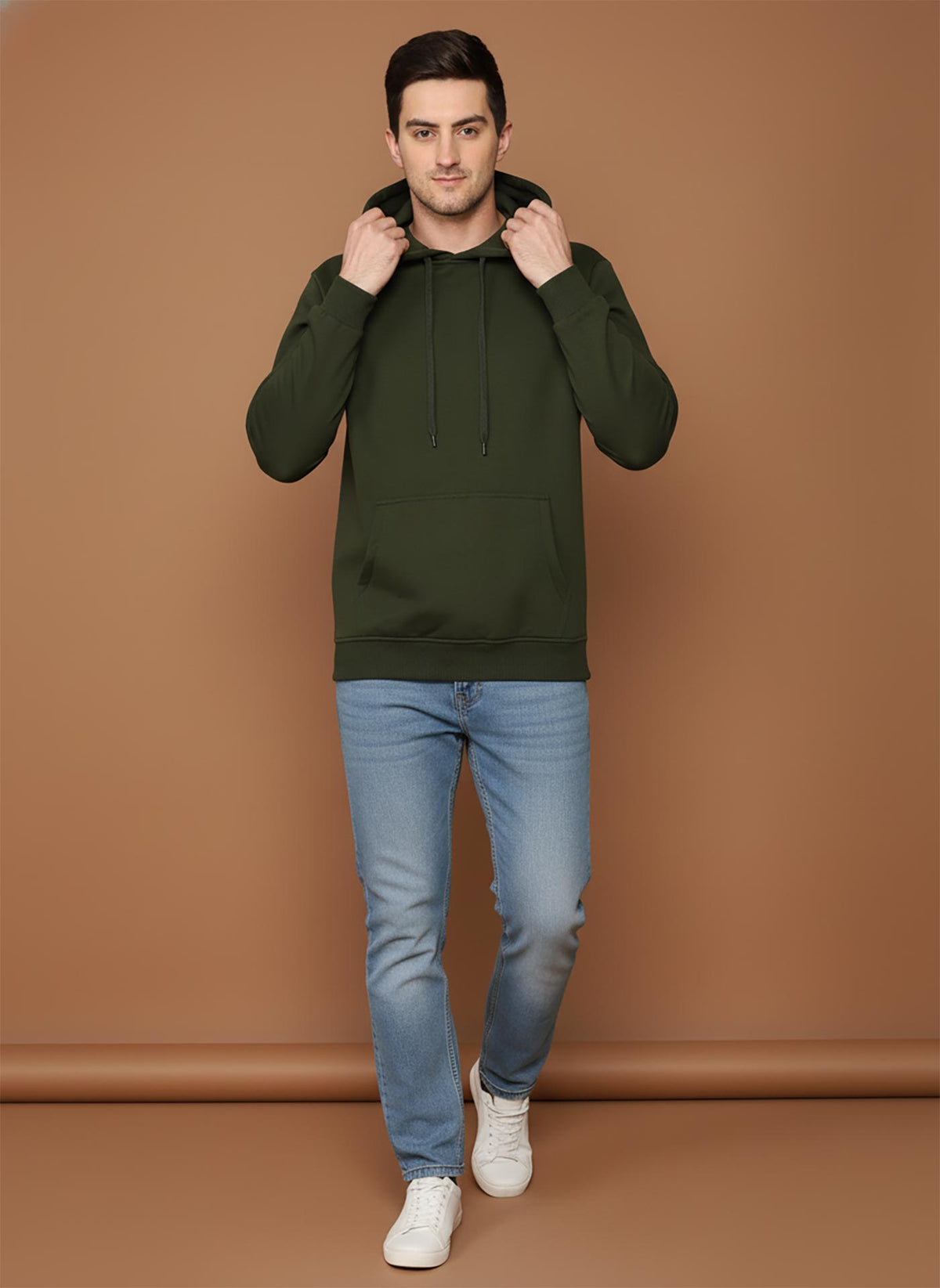 SN360 men’s olive green hoodie walking pose styled with slim fit jeans and white sneakers for casual wear