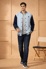 SN366 men's cotton fleece varsity bomber jacket, powder blue and navy slim fit, walking pose with sneakers