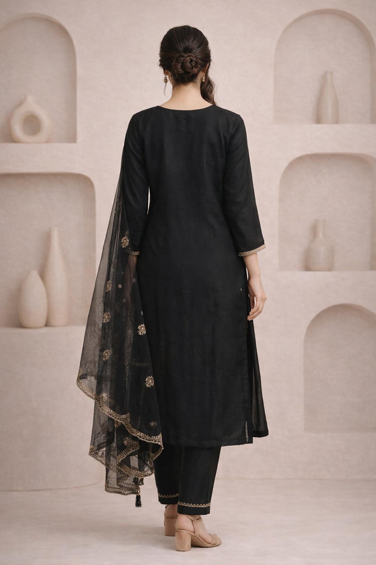 Midnight black kurta set back view, straight silhouette, three-quarter sleeves, sheer embroidered dupatta, beige heels.