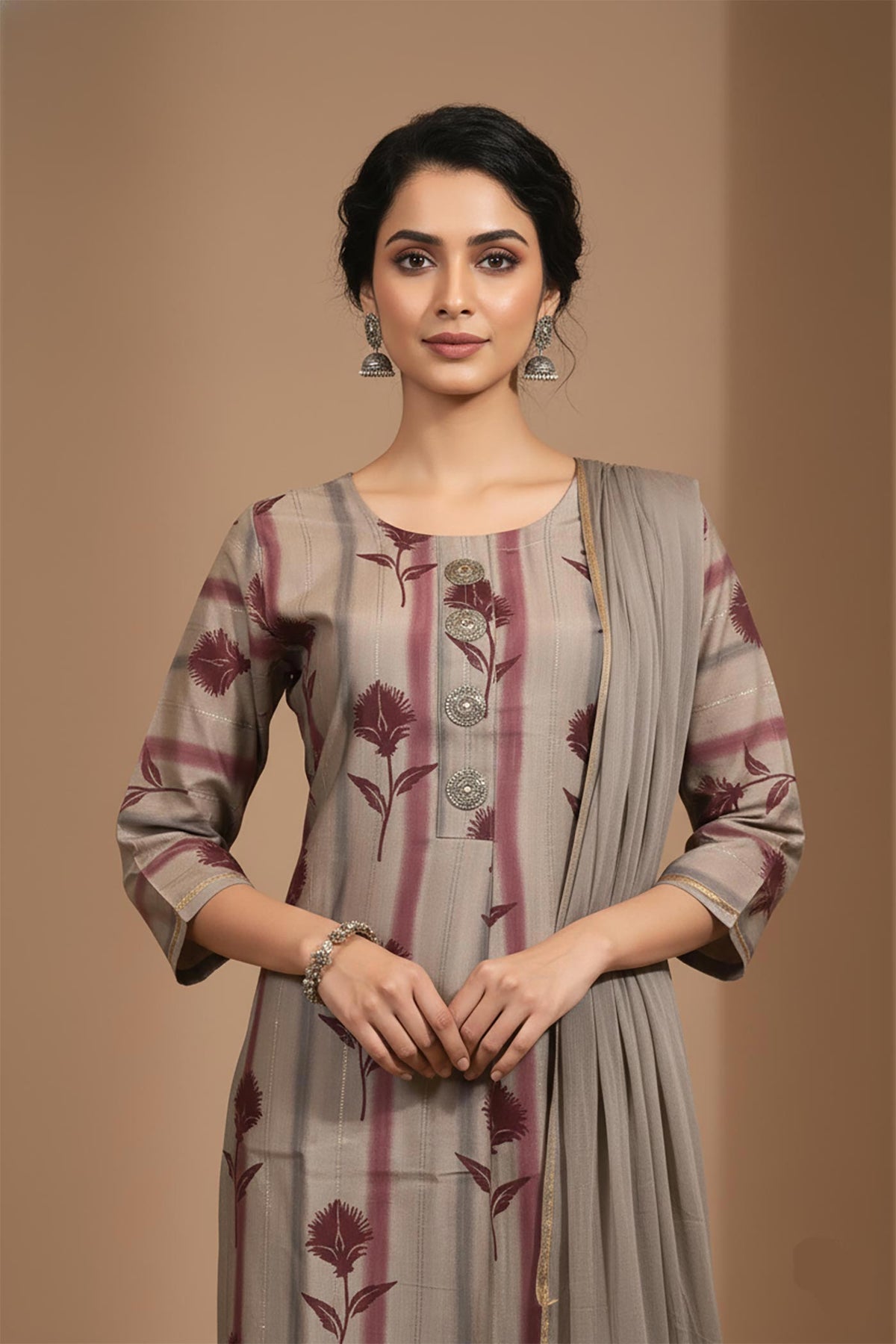 Round neck grey kurta with maroon floral print, metallic buttons, three-quarter sleeves, dupatta detail.