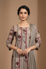 Round neck grey kurta with maroon floral print, metallic buttons, three-quarter sleeves, dupatta detail.