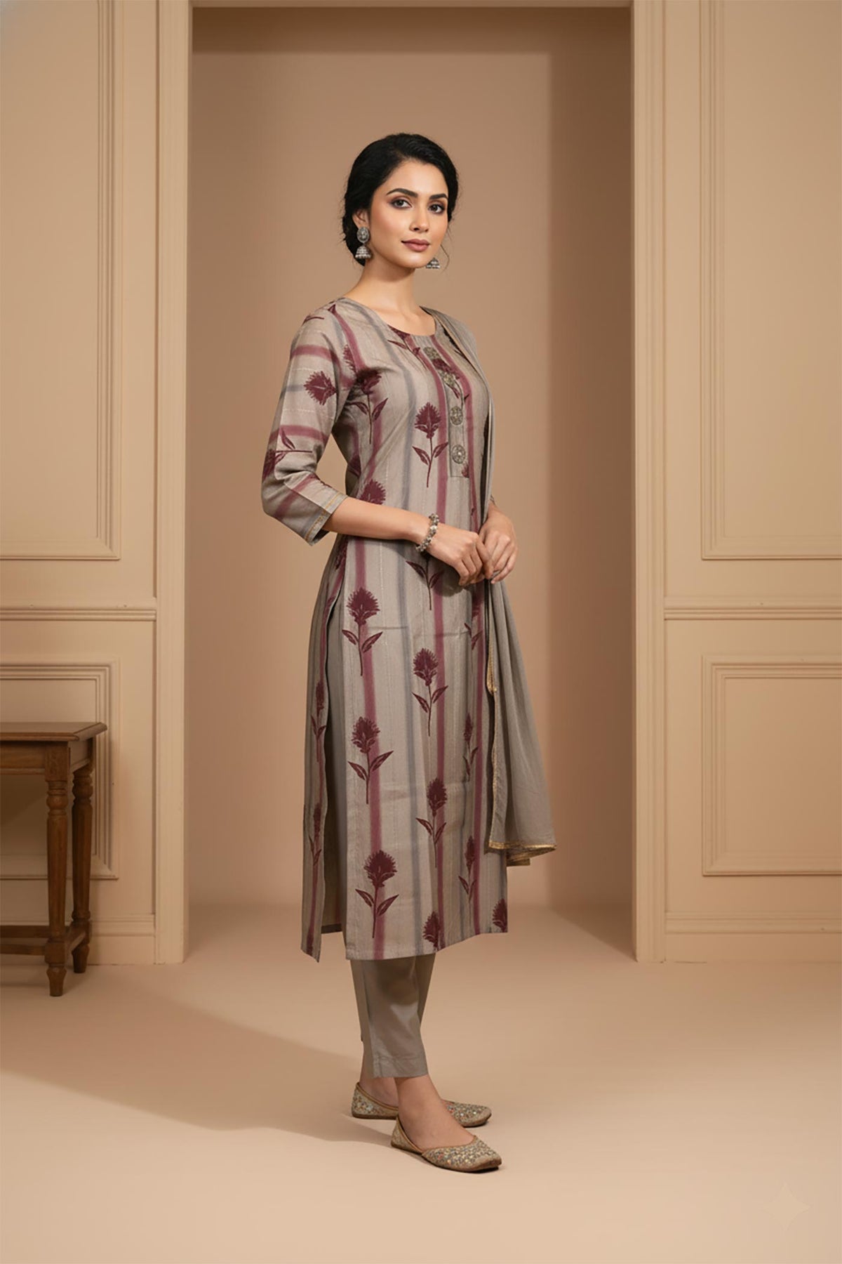 Side angle grey printed kurta set with three-quarter sleeves, straight pants, styled with embellished juttis.