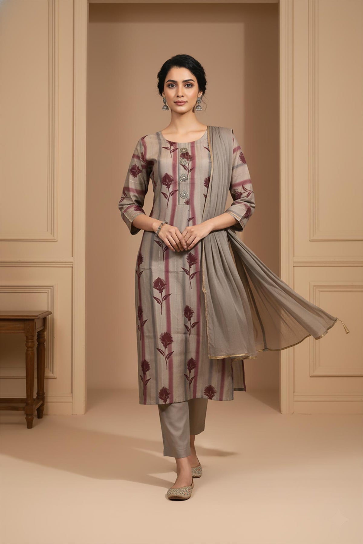 Taupe grey kurta set with maroon botanical stripes, straight fit, dupatta flowing, paired with embroidered juttis.