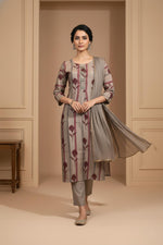 Taupe grey kurta set with maroon botanical stripes, straight fit, dupatta flowing, paired with embroidered juttis.