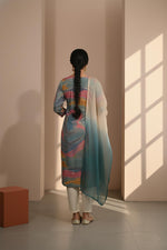 Multicolor printed kurta set with flowing ombre dupatta, straight silhouette, back view with ivory pants and flats.