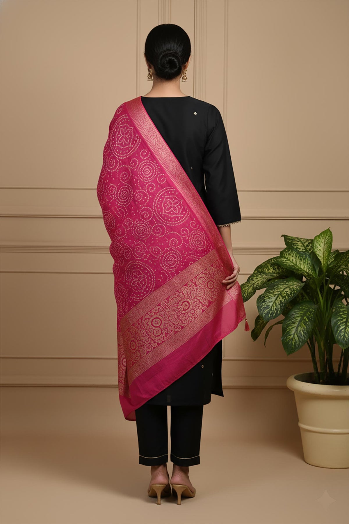 Black kurta set back view with pink bandhani dupatta drape and straight pants styling.
