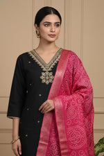 Close-up of black kurta V-neck gold embroidery with pink bandhani dupatta detail.