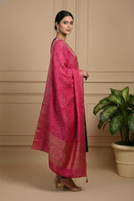 Side view of black kurta set with flowing pink bandhani dupatta and gold heels styling.