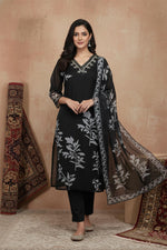 Black floral kurta set in motion, sheer dupatta flowing, paired with embroidered ethnic flats.