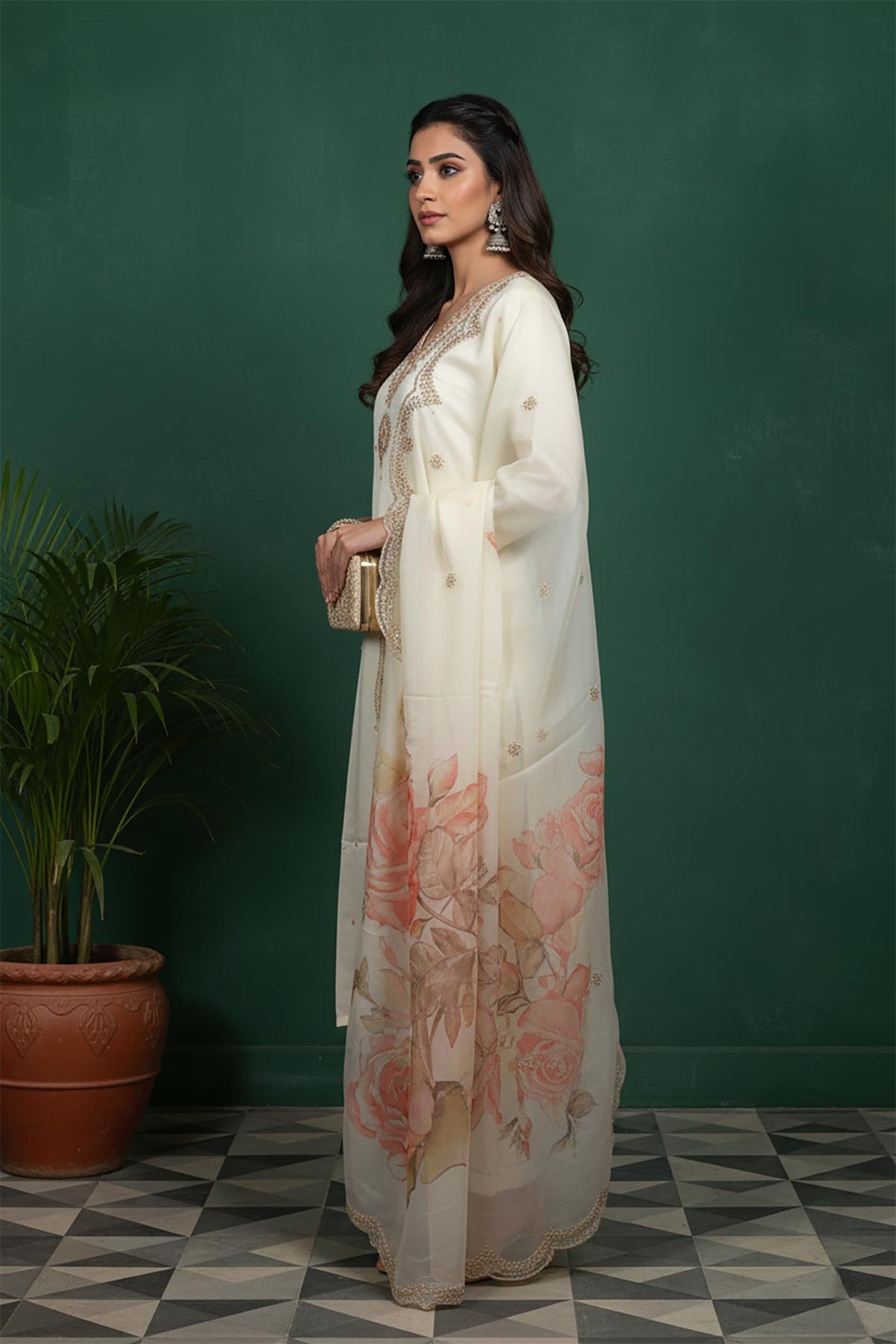 Side view of ivory embroidered kurta set with flowing organza dupatta and floral print, paired with block heels.