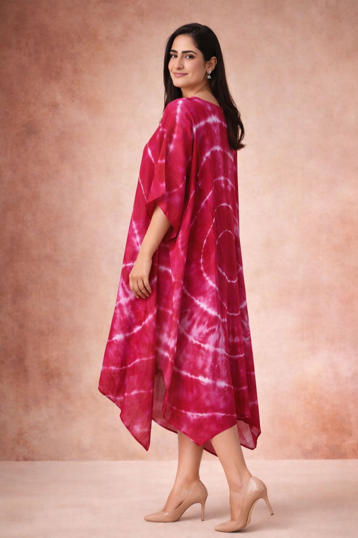 Side view of crimson tie-dye kaftan dress with flowy asymmetric hem and relaxed silhouette.