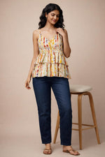 Multicolor tiered camisole top front view styled with dark blue jeans and tan sandals.