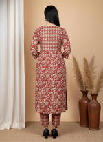 Back view terracotta floral kurta set with diamond pattern yoke and printed pants, paired with black heels.