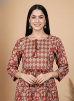 Close-up terracotta kurta diamond yoke with tassel tie-up neckline and floral print fabric.