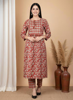 Front view terracotta floral kurta pant set with diamond yoke panel, three-quarter sleeves, styled with black heels.