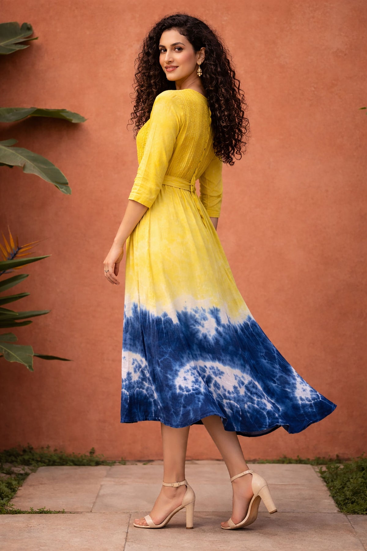Side view of yellow and blue tie-dye cotton midi dress with waist belt and three-quarter sleeves