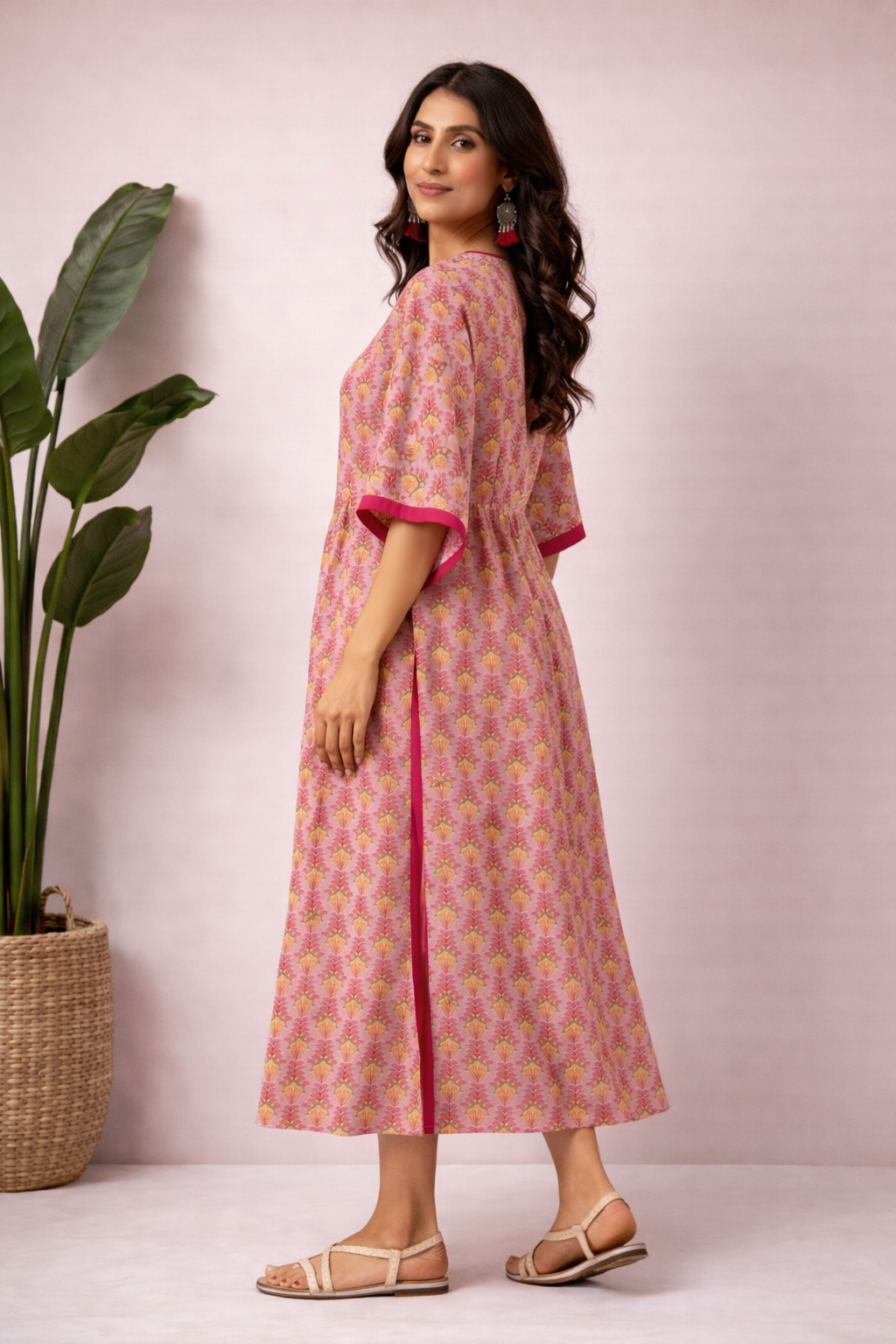 Side view of pink and mustard cotton handblock print kaftan kurti with elbow sleeves and side slit detail