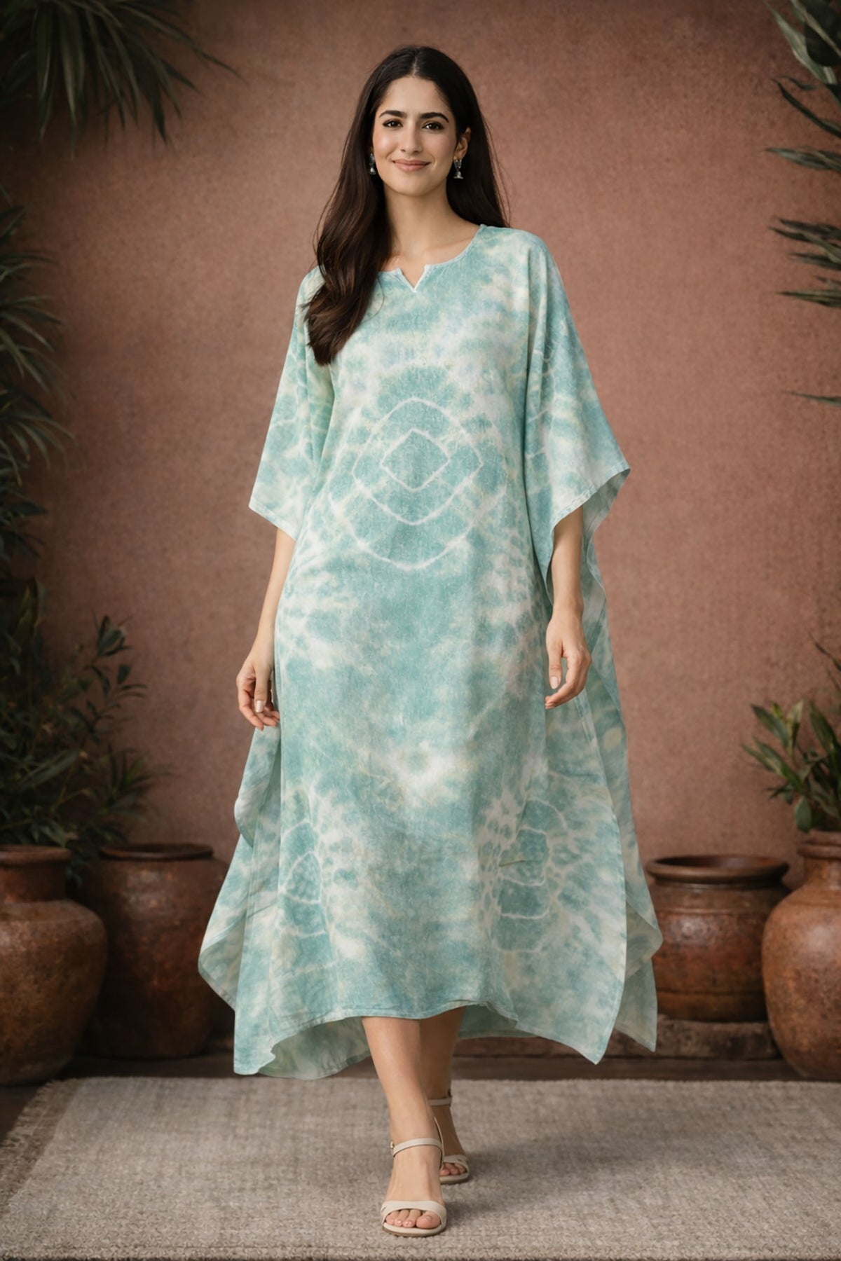 Woman walking in mint green tie dye kaftan dress showing flowy movement and relaxed fit
