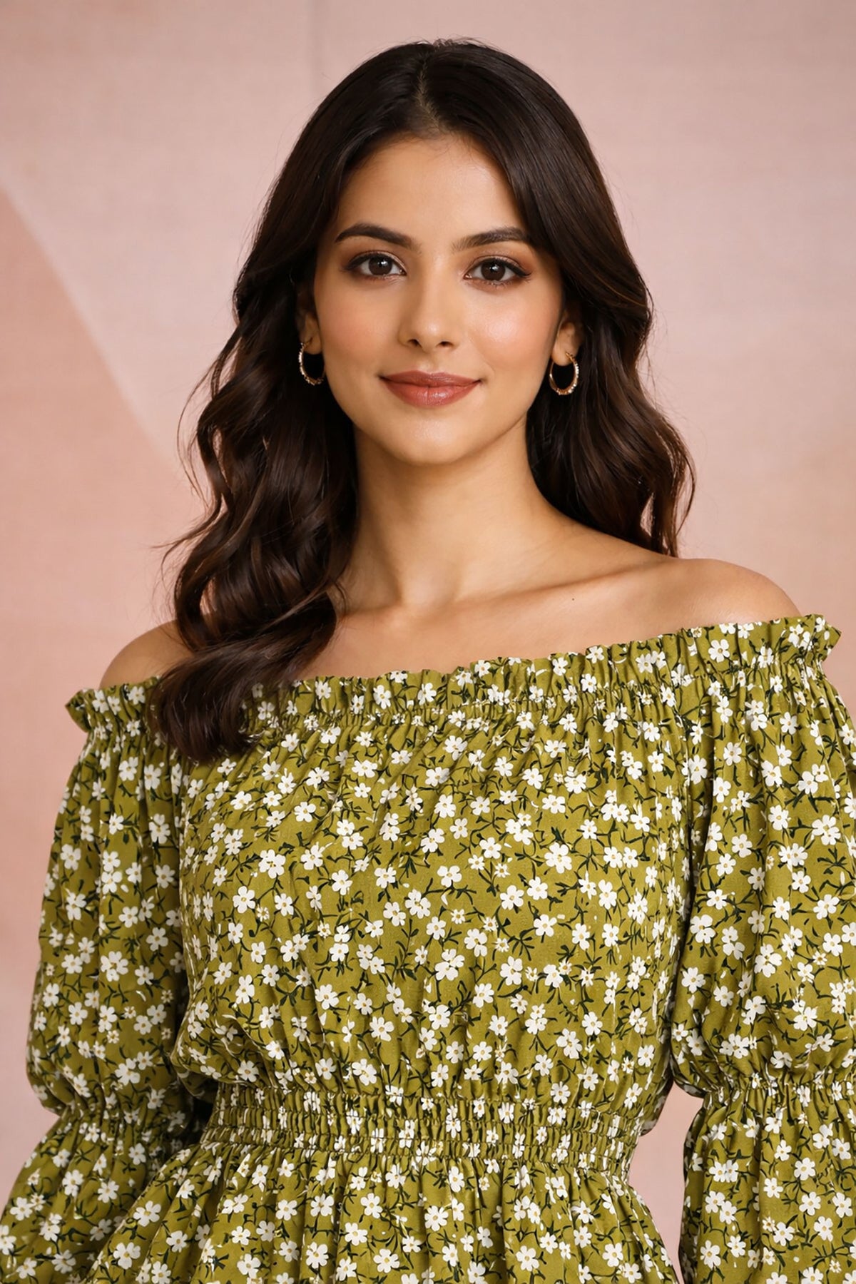 Woman wearing a green floral off-shoulder dress against a pink background