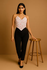 White red-print halter crop top with handkerchief hem, walking pose, paired with black trousers and pumps.